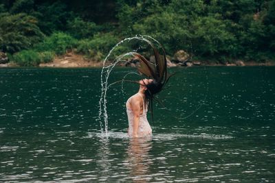 Full length of woman standing in water