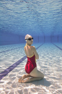 Portrait of young female model posing in pool