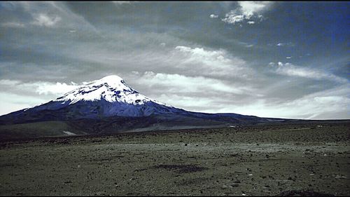 Scenic view of mountains against cloudy sky