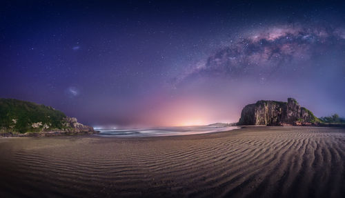 Scenic view of beach against sky at night