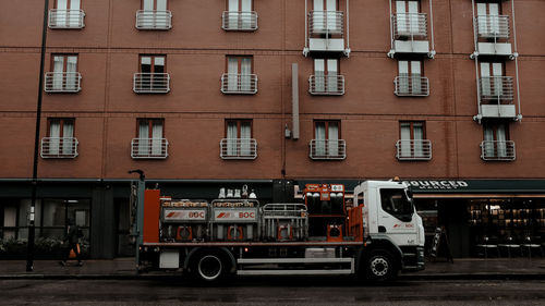 Cars parked on road by building