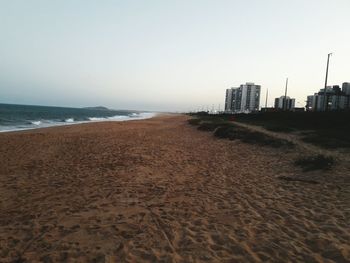 View of beach with city in background