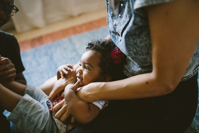 High angle view of baby girl with mother and father at home