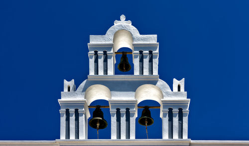 Low angle view of bell tower against blue sky