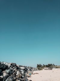 Scenic view of beach against clear blue sky