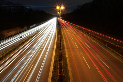 High angle view of light trails on highway at night