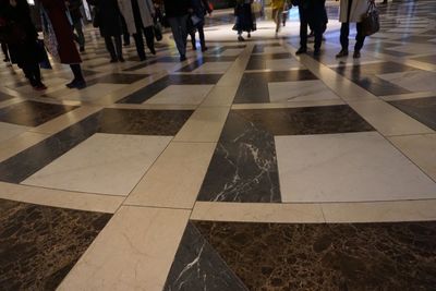 Low section of people walking on zebra crossing