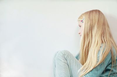 Portrait of young woman against white background