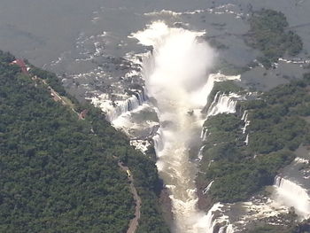 High angle view of waterfall by sea against sky