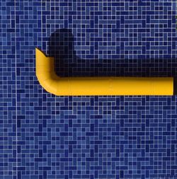 Yellow tube on blue wall