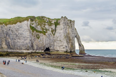 Group of people on rock at beach