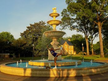 Fountain in front of swimming pool against sky