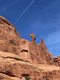 Low angle view of rock formation against blue sky