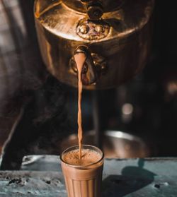 Close-up of coffee pouring in glass