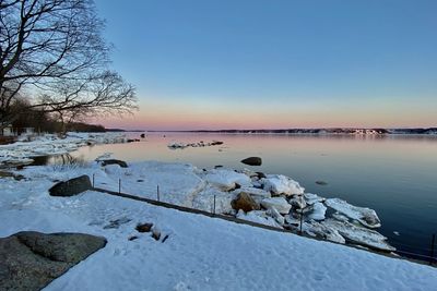 Scenic view of frozen lake against sky during winter