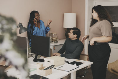 Businesswoman planning strategy with team at office