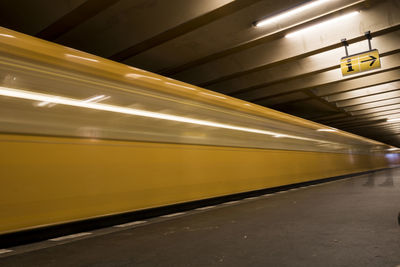 Blurred motion of train at railroad station