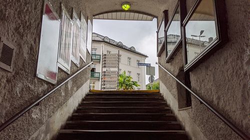 Low angle view of staircase amidst buildings