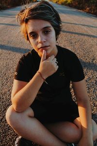 Portrait of beautiful young woman sitting outdoors