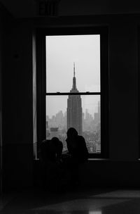 People on building seen through window