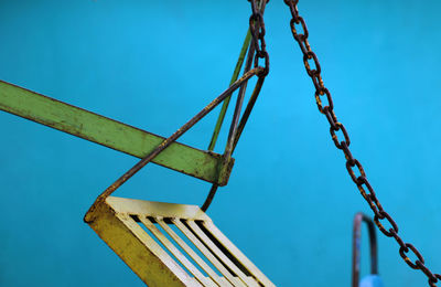 Low angle view of swing against clear blue sky