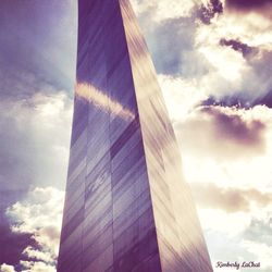 Low angle view of modern building against cloudy sky