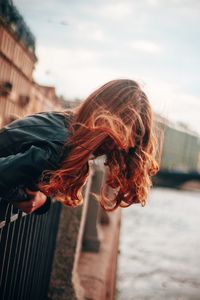 Midsection of woman standing against sky