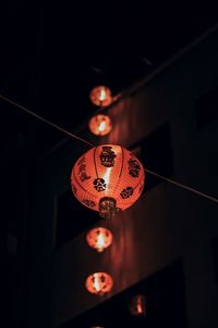 Low angle view of illuminated lantern hanging at night