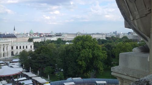 Buildings in city against cloudy sky