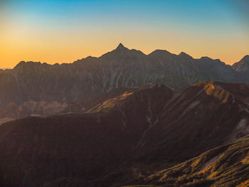 Scenic view of mountains against clear sky during sunset