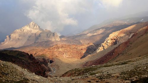 Scenic view of mountains against cloudy sky