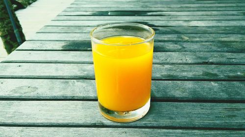 Close-up of orange juice in glass on table