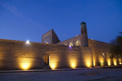 Illuminated buildings against sky at night