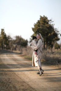 Young woman standing on road
