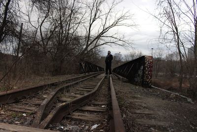 High angle view of railroad track amidst trees against sky