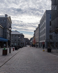 Street amidst buildings in city against sky