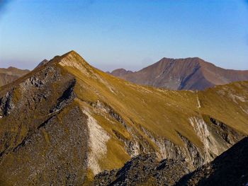 Scenic view of mountains against clear blue sky