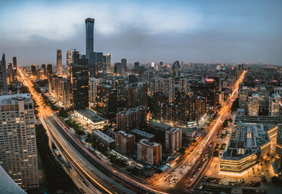 High angle view of illuminated city buildings against sky