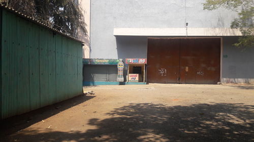 Empty road amidst buildings in city