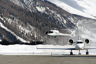 Helicopter against snowcapped mountain