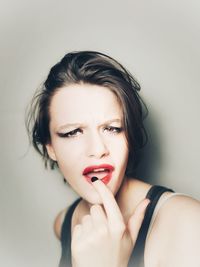 Portrait of beautiful woman against white background
