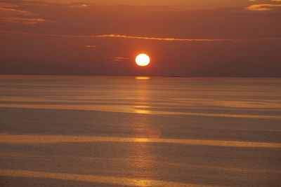 Scenic view of sea against romantic sky at sunset