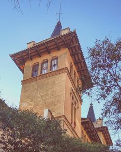 Low angle view of building against clear blue sky