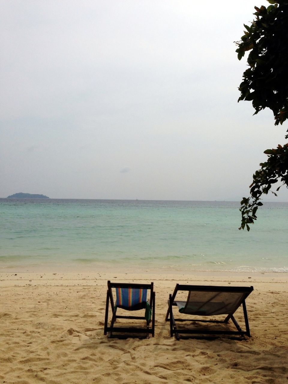 horizon over water, sea, beach, water, tranquil scene, tranquility, scenics, sand, shore, beauty in nature, sky, nature, absence, idyllic, empty, vacations, clear sky, chair, calm, remote