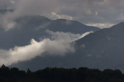 Scenic view of clouds over mountains