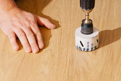 Cropped hands of man working at shop