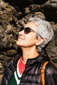 Portrait of woman wearing mask on rock