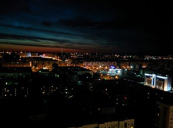 Illuminated cityscape against sky at night