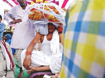 Senior man with headdress sitting outdoors