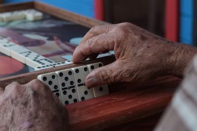 Cropped hands playing domino